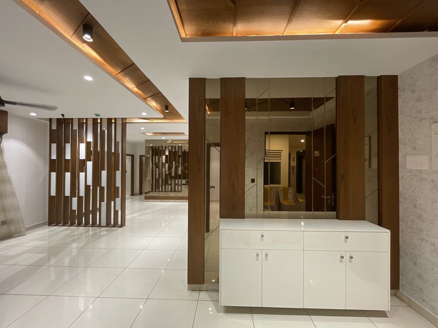 Foyer and living area with mirrored feature wall and white console unit